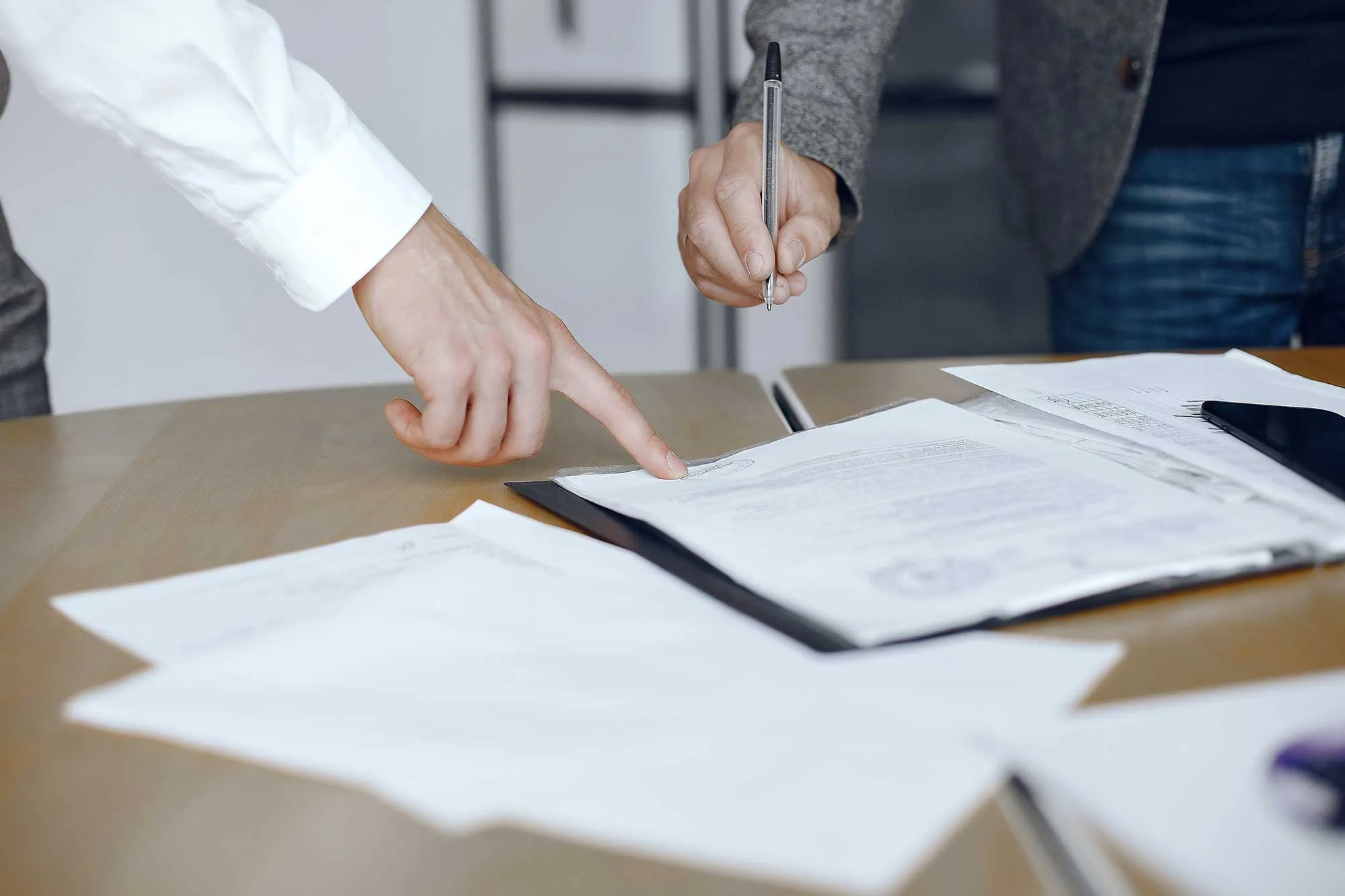 Personas firmando y notarizando un documento en la oficina